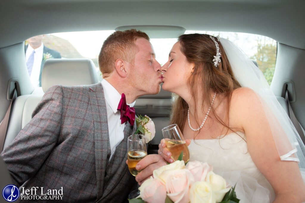 Bride and Groom kiss in wedding car on the way to Alveston Pastures Farm Stratford upon Avon