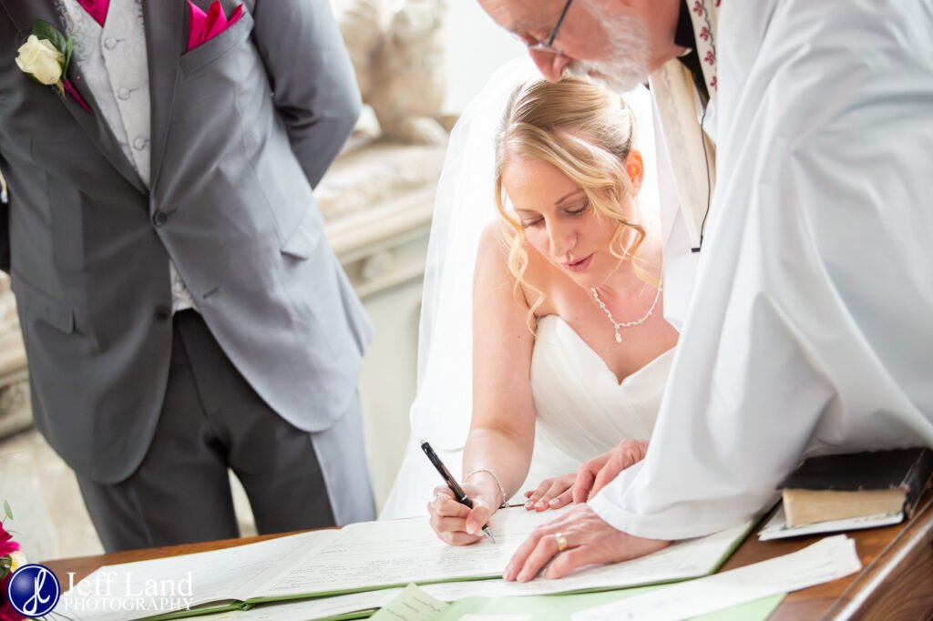 Traditional wedding signing of the registrar at St Peters Church Wootton Wawen