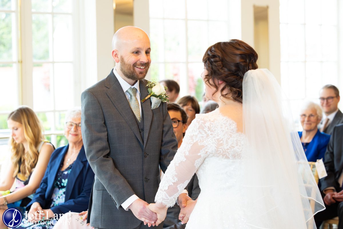 Groom looking at Bride during Wedding Ceremony at Warwick House
