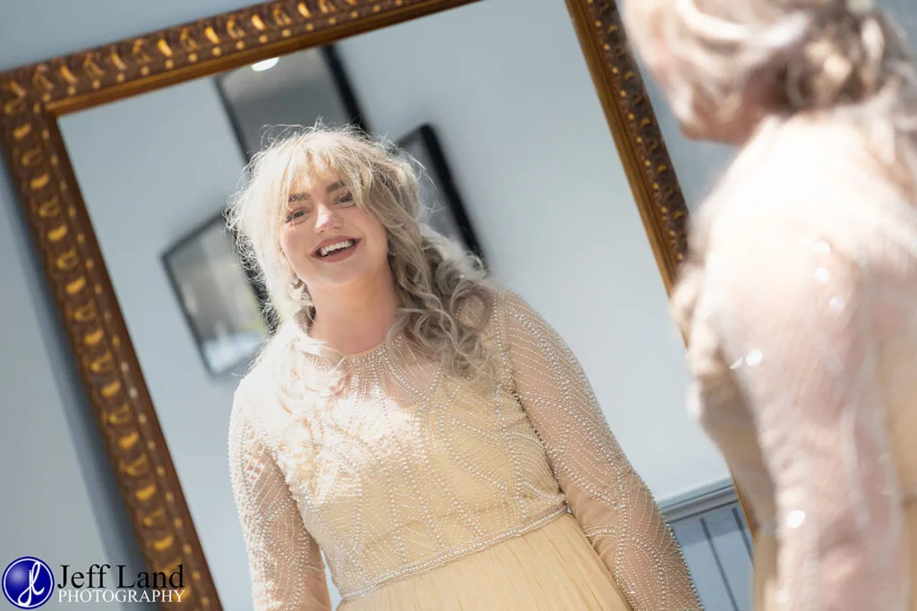 Happy Bride Wedding Photo Looking in Mirror