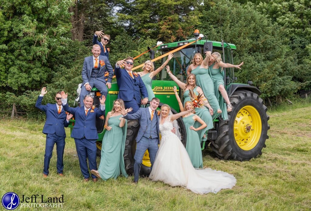 Fun Bridal Party group photo on a John Deere Tractor at Holy Trinity Church Arrow