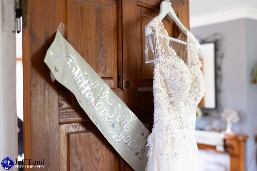 Wedding dress details hanging on door