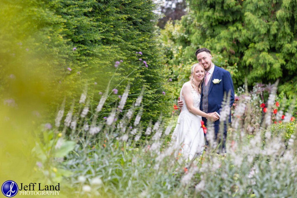 Wedding Reception at Alveston Pastures Farm Stratford upon Avon, Warwickshire bride and groom portrait in flower garden