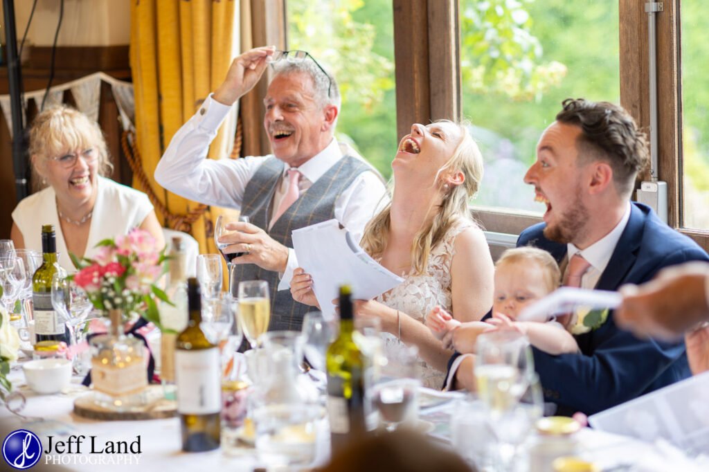 Wedding Reception at Alveston Pastures Farm Stratford upon Avon, Warwickshire bride laughing at speeches