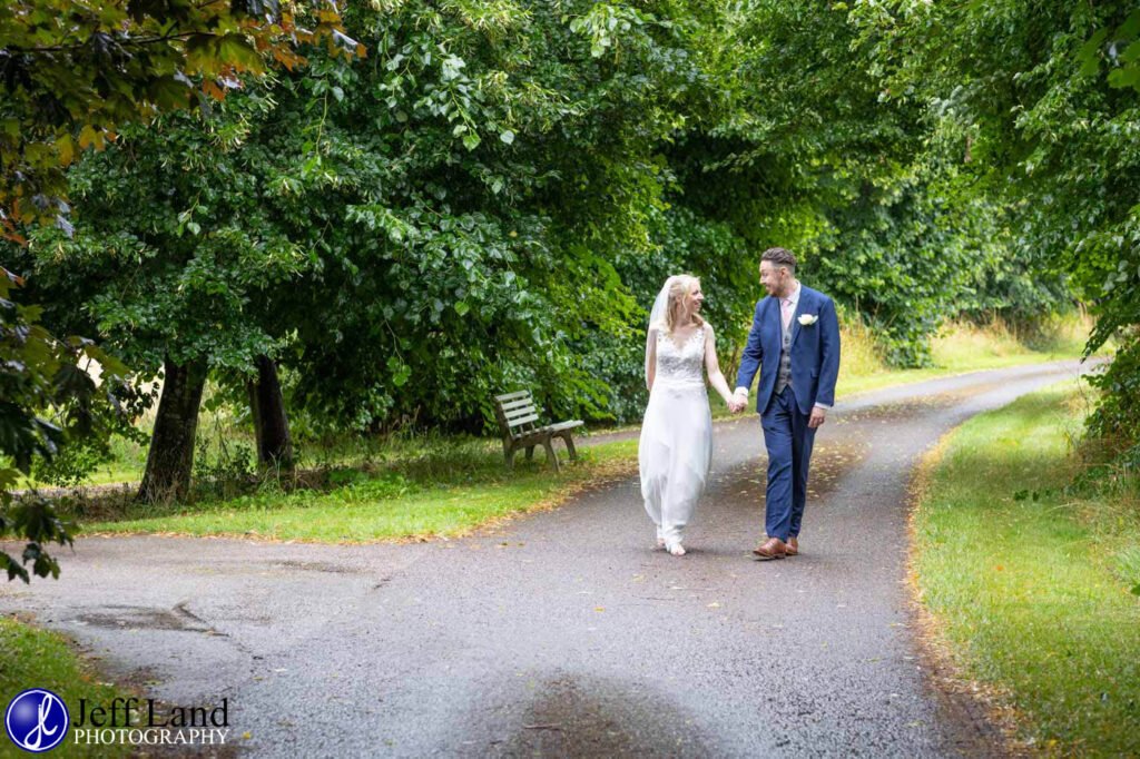 Wedding Reception at Alveston Pastures Farm Stratford upon Avon, Warwickshire bride and groom walking portrait