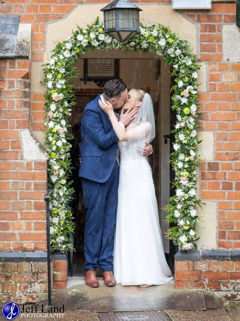 Wedding St Andrews Church Stratford upon Avon, Warwickshire passionate kiss in the church door