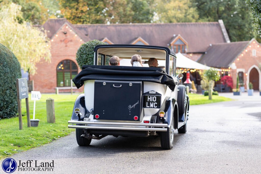 Bride and Groom arrive in wedding car at Nuthurst Grange