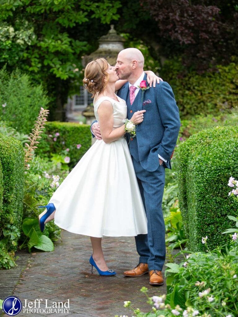 Bride and Groom kiss wedding portrait in rear gardens at the Lord Leycester Hospital in Warwick