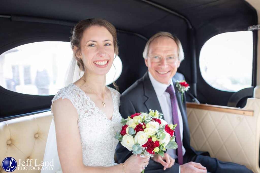 Bride with dad setting off to get married in wedding car