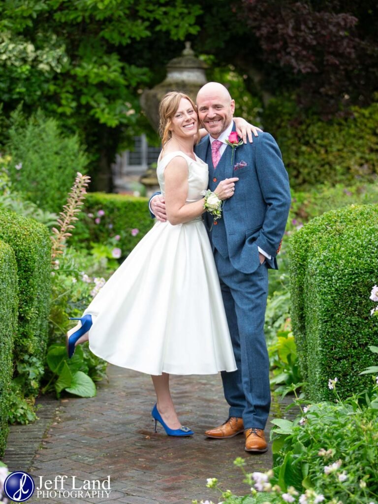 Fun Bride and Groom wedding portrait in rear gardens at the Lord Leycester Hospital in Warwick