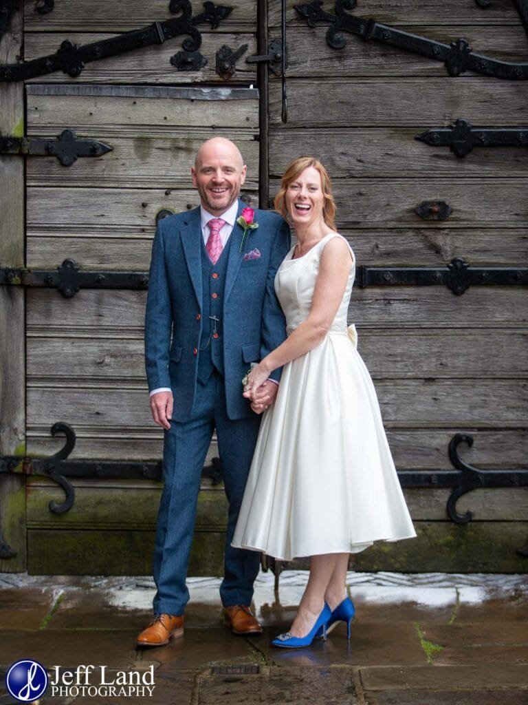 Happy Bride and Groom wedding portrait by main gate at the Lord Leycester Hospital in Warwick